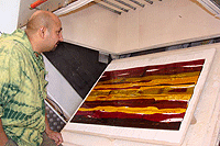 Day 3 of glass fusing and slumping course Abhai Pandaya inspects his wall panel